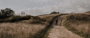 Preview wallpaper man, field, path, sky, clouds