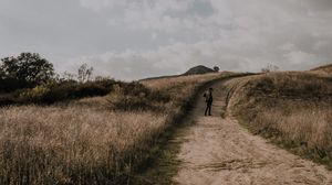 Preview wallpaper man, field, path, sky, clouds