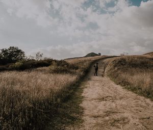 Preview wallpaper man, field, path, sky, clouds