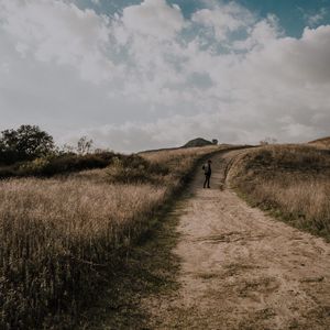 Preview wallpaper man, field, path, sky, clouds
