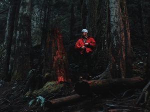 Preview wallpaper man, forest, trees, logs, nature