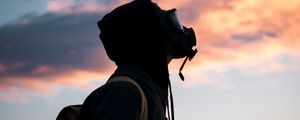 Preview wallpaper man, gas mask, sunset, sky