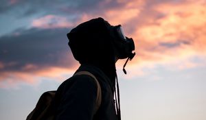 Preview wallpaper man, gas mask, sunset, sky