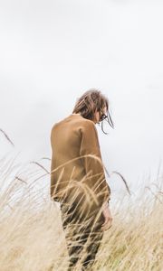 Preview wallpaper man, grass, loneliness, spikelets, field