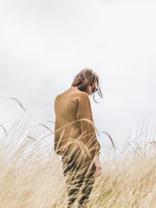 Preview wallpaper man, grass, loneliness, spikelets, field