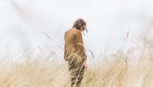 Preview wallpaper man, grass, loneliness, spikelets, field