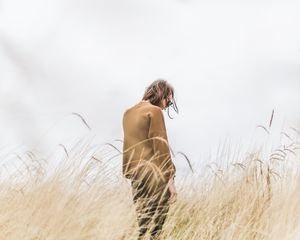 Preview wallpaper man, grass, loneliness, spikelets, field