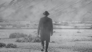 Preview wallpaper man, hat, mountains, snow, black and white, bw