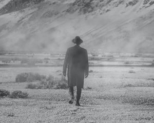 Preview wallpaper man, hat, mountains, snow, black and white, bw