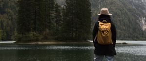 Preview wallpaper man, hat, river, trees, mountain, travels