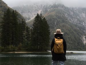 Preview wallpaper man, hat, river, trees, mountain, travels