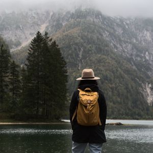 Preview wallpaper man, hat, river, trees, mountain, travels