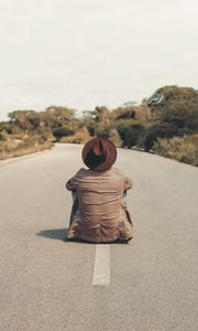 Preview wallpaper man, hat, road, asphalt, loneliness