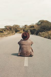 Preview wallpaper man, hat, road, asphalt, loneliness