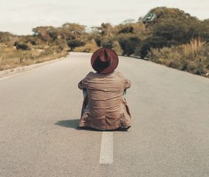 Preview wallpaper man, hat, road, asphalt, loneliness