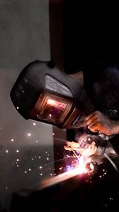 Preview wallpaper man, helmet, welding, sparks