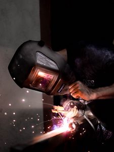 Preview wallpaper man, helmet, welding, sparks