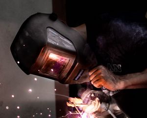 Preview wallpaper man, helmet, welding, sparks