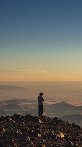 Preview wallpaper man, hill, stones, horizon, overview