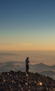Preview wallpaper man, hill, stones, horizon, overview