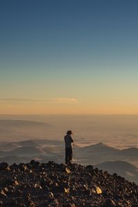 Preview wallpaper man, hill, stones, horizon, overview
