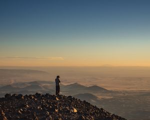 Preview wallpaper man, hill, stones, horizon, overview