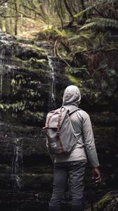 Preview wallpaper man, hood, backpack, waterfall