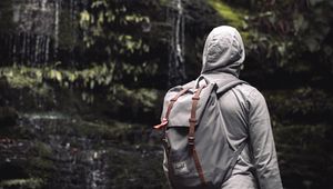 Preview wallpaper man, hood, backpack, waterfall