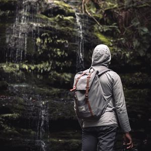 Preview wallpaper man, hood, backpack, waterfall