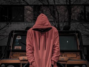 Preview wallpaper man, hood, hoodie, car, jeep