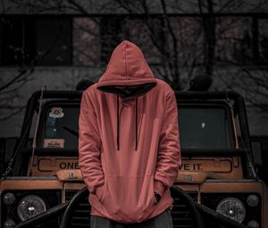 Preview wallpaper man, hood, hoodie, car, jeep