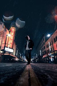 Preview wallpaper man, hood, night city, snowfall, street