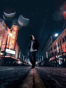 Preview wallpaper man, hood, night city, snowfall, street