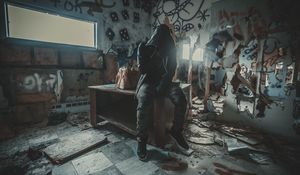 Preview wallpaper man, hood, ruins, room, graffiti