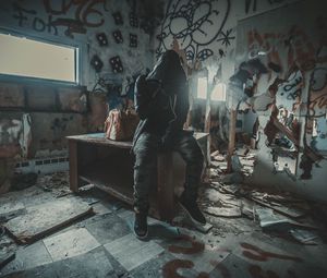 Preview wallpaper man, hood, ruins, room, graffiti