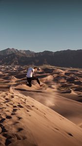 Preview wallpaper man, jump, desert, dunes, sand