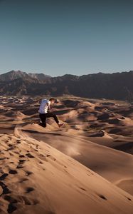 Preview wallpaper man, jump, desert, dunes, sand