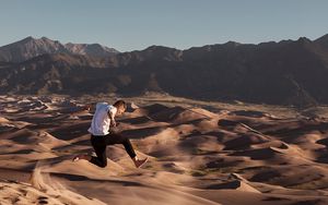 Preview wallpaper man, jump, desert, dunes, sand