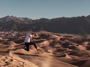 Preview wallpaper man, jump, desert, dunes, sand