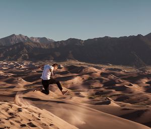 Preview wallpaper man, jump, desert, dunes, sand