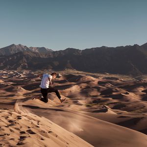 Preview wallpaper man, jump, desert, dunes, sand