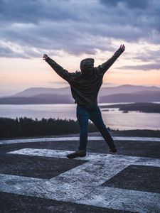 Preview wallpaper man, jump, freedom, lake, mountains, twilight