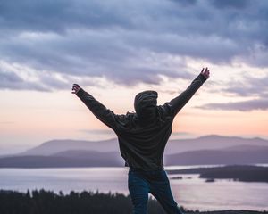 Preview wallpaper man, jump, freedom, lake, mountains, twilight