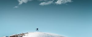 Preview wallpaper man, jump, hill, snow, sky