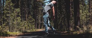 Preview wallpaper man, jump, levitate, road, trees, forest