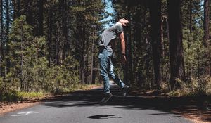 Preview wallpaper man, jump, levitate, road, trees, forest