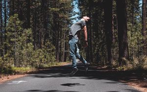 Preview wallpaper man, jump, levitate, road, trees, forest