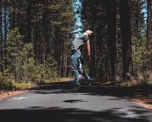 Preview wallpaper man, jump, levitate, road, trees, forest