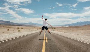 Preview wallpaper man, jump, levitation, road, desert