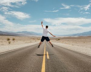 Preview wallpaper man, jump, levitation, road, desert